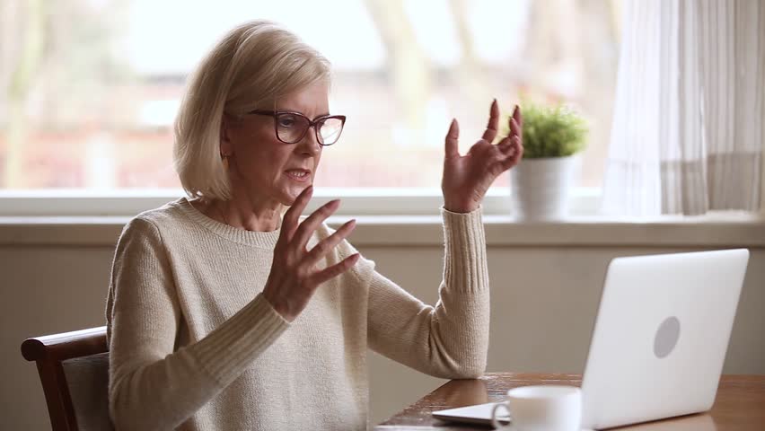 Stressed senior middle aged businesswoman annoyed using stuck laptop, angry mature old lady mad about computer problem frustrated with data loss, online mistake, software error or system failure | Shutterstock HD Video #1024093997