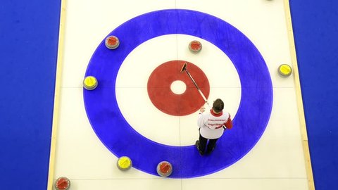 Pale, Bosnia and Herzegovina, February 11th 2019, EYOF - Curling rocks on ice at the Olympic Winter Games. Athletes Playing Curling. Winter sport. Curling Granite Stone and Broom. Championship 