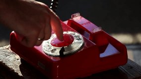 Dialing a Number on Retro Rotary Red Phone - Powered by Shutterstock - Get 15% off with code: PIKWIZARD15