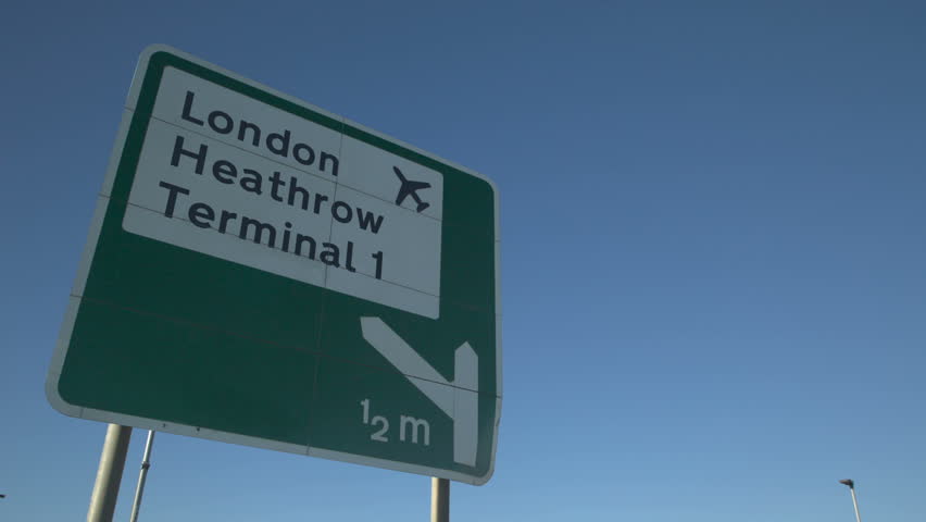 Heathrow Airport Sign with aircraft Flyover: Road sign for london heathrow airport with jet airliner flying overhead Royalty-Free Stock Footage #1024107233