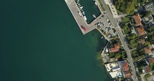 A small port on the bay of Kotor. Birds eye aerial view of the shoreline in Risan, Montenegro.