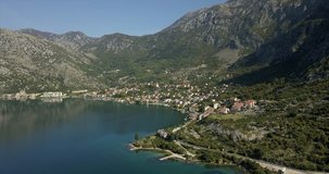 Aerial shot of Risan in Montenegro. ruins in the foreground on the bay of Kotor and mountains in the distance