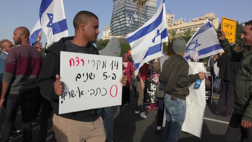 Sign says 5 murders 0 bills of indictment when Israeli Ethiopians demonstrating against police brutality and police state while blocking traffic. Tel Aviv, Israel, January 30, 2019