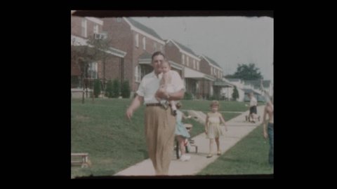 Baltimore, Maryland, USA- 1956: Proud father shows off cute chubby baby