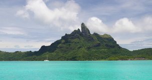 Mount Otemanu, Bora Bora, Tahiti, French Polynesia with yacht, coral lagoon sea and Mt Pahia, Mt Otemanu, Tahiti, south Pacific Ocean. 4K, 59.94 FPS slow motion.