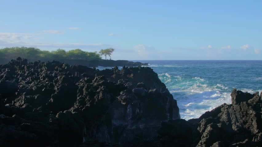 Waves crashing into shore on Hawaii