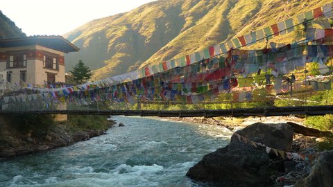 Suspension bridge covered in prayer flags near Paro, Bhutan
