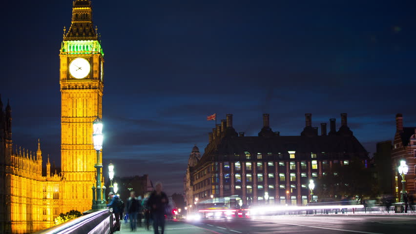 London, England time lapse of Big Ben and traffic on Westminster Bridge and UK Parliament city street with night lights. Famous British landmark illuminated.