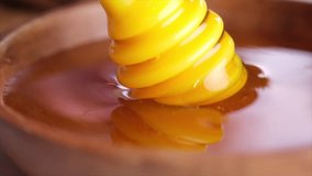 Close up footage of honey on wooden table. Selective focus.
