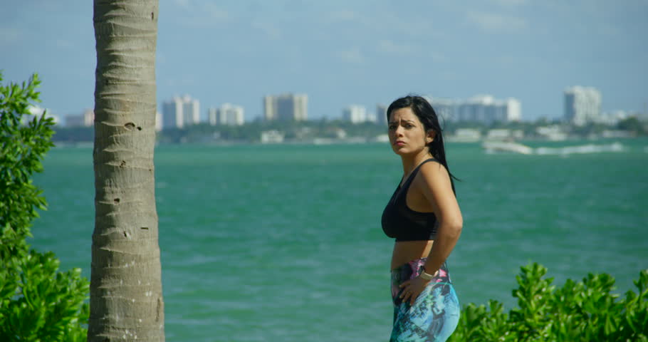 FIT GIRL WORKING OUT IN FRONT OF THE OCEAN