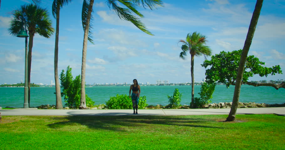 YOUNG FIT GIRL RUNNIN AND WORKING OUT IN FRONT OF THE OCEAN