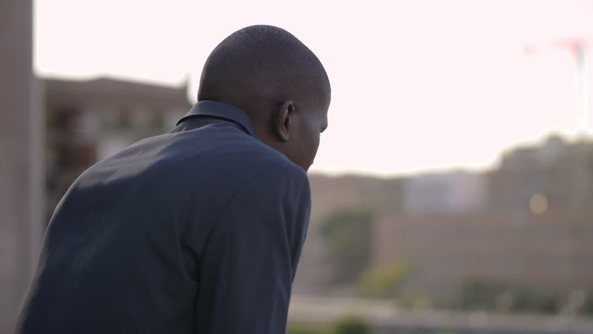 Worried handsome young african american businessman contemplating the city | Shutterstock HD Video #1024140767