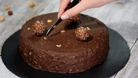 Pastry chef decorated chocolate cake with a gold leaf cake. - Powered by Shutterstock - Get 15% off with code: PIKWIZARD15