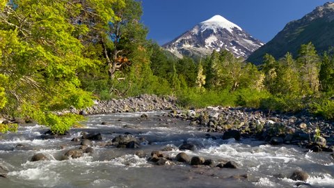 Lanin volcano in Lanin national park. Landscape with volcano, mountain river and green trees. Argentina, Patagonia, Lake district