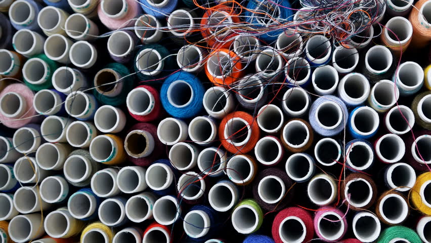 top view on multi-colored threads in the box. Set of multicolored threads.Home crafts. Seamstress workplace details