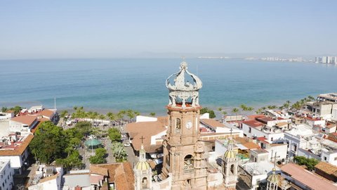 Downtown Puerto Vallarta Mexico Old Town Filmed with 4k Aerial Drone. Shot of Lady Guadalupe Church and Surrounded By the City, Plaza, Malecon and Beach During Sunny Day.