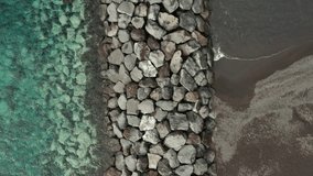 Ocean water and stones on the beach from top point of view