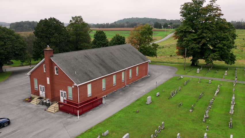 Meetinghouse with graveyard to tractor and pumpkin patch near Baumgardener