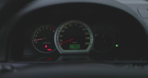 car dashboard close-up with flashing turn signals