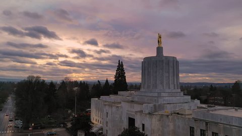Dawn Sun Shines Through Clouds at The State Capital Building in Salem