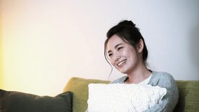 Young asian girl watching a tv.