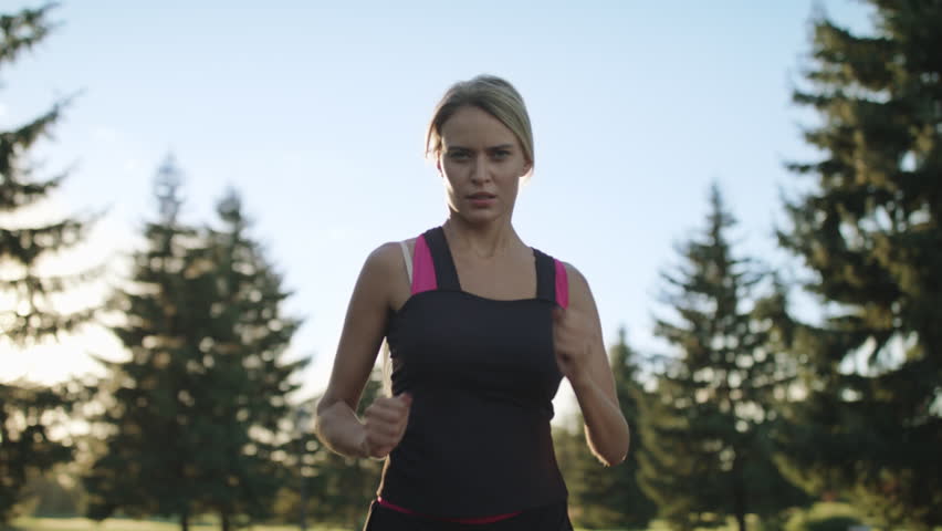 Young woman runner training in summer park. Close up fitness woman jogging outdoor. Tired girl jogger breathing after run marathon in park. Morning running concept Royalty-Free Stock Footage #1024182815