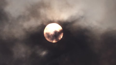 Sun covered by black clouds of smoke