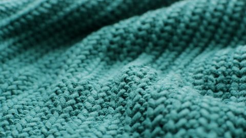 The texture of the fabric. Green knitted texture. Close-up. Can be used as a background. HD