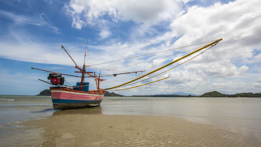 fishing boat at peaceful tropical beach, timelapse