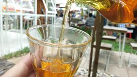 Teapot pouring tea in cup on wood table. - Powered by Shutterstock - Get 15% off with code: PIKWIZARD15