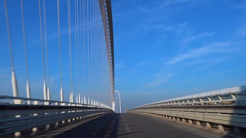 Reggio Emilia/Italy - 02/15/2019: Blue sky of a vehicle-mounted video. Traveling by car the Calatrava Bridge in Reggio Emilia