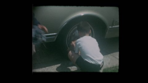 Baltimore, Maryland, USA - 1964: Young boys wash vintage antique car