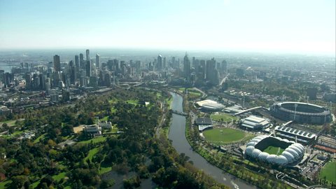 An aerial approach shot towards Melbourne city from south along Yarra River