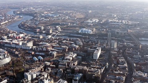 Newcastle upon Tyne aerial view is a university city on the River Tyne in northeast England flying over famous Spanning the Tyne, modern iconic landmark Gateshead Millennium Bridge in the UK - HD 4K 