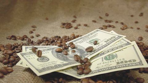 Coffee grains fall on American dollars, grains pour on money