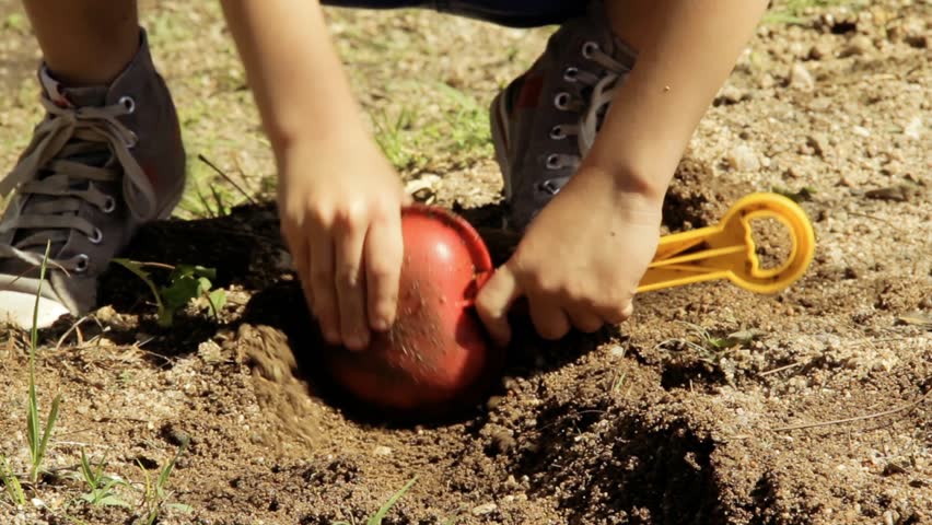 Hands of a Young Kid Playing with a Plastic Shovel Digging in the Dirt. Close Up. Royalty-Free Stock Footage #1024244468