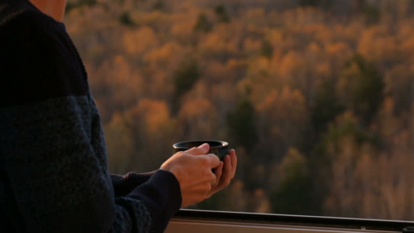 Man drinking tea at the window