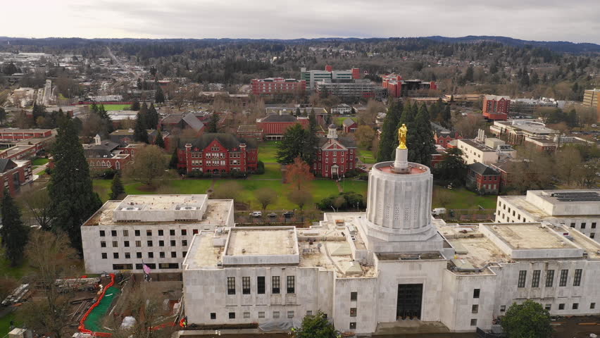 Dawn Sun Shines Through Clouds at The State Capital Building in Salem