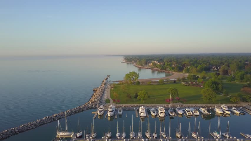 AERIAL: lifting past the harbor perpendicularly to the shoreline of Kenosha.