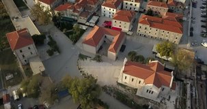 Close up Aerial shot of Ston, an ancient walled city in Croatia. camera pans up to show a wide view of the walls on the hill.
