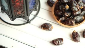 Top view of dried dates fruit on wooden table. Selective focus. Tracking shot.