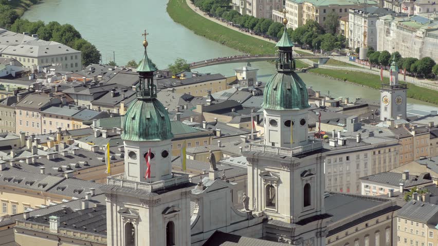 two amazing towers with bronze domes of Salzburg Cathedral in background of city view