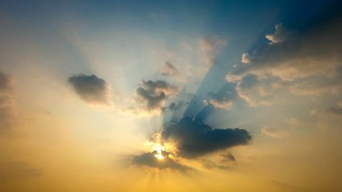 Time lapse sun shines through white clouds caused rays of light on hazy day blue sky