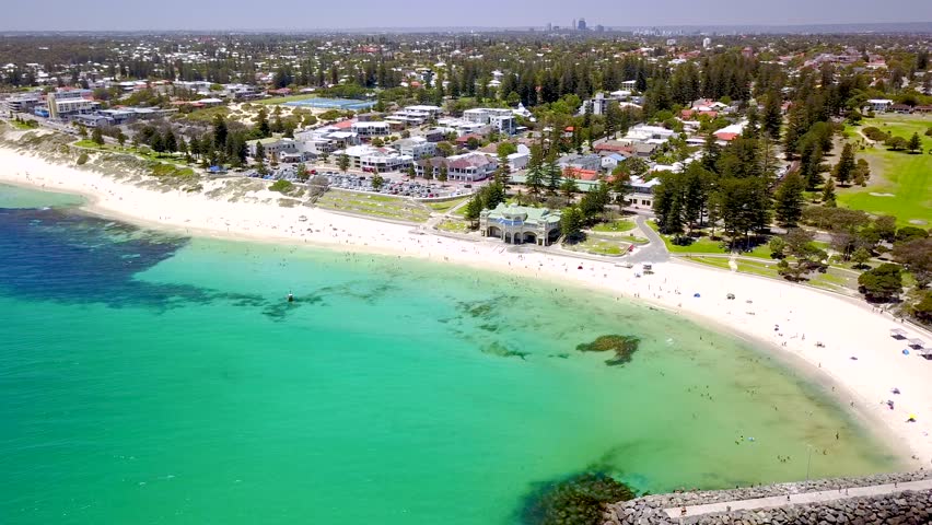 Summer day at Cottesloe Beach and the Indiana Tea House in Perth, Western Australia, Australia. Perth coastal aerial (drone) video footage. Royalty-Free Stock Footage #1024279544