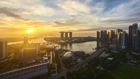 4k time lapse of dramatic sunrise over Singapore city skyline. Pan right