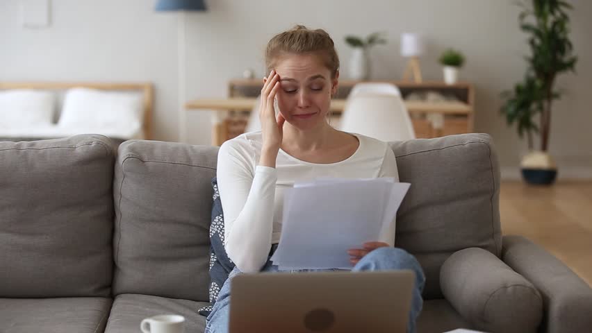 Stressed teen girl student feeling worried reading bad news in paper letter, sad depressed woman concerned about financial problem, bank debt bills, failed exam test failure results notification Royalty-Free Stock Footage #1024307186