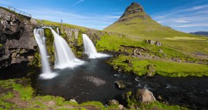 Iceland time lapse video of waterfall and famous mountain. Kirkjufellsfoss and Kirkjufell in northern Iceland nature landscape. Timelapse photography in 4K.