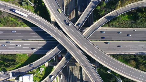 Aerial drone top down video of modern highway multilevel junction with interchange crossing road 