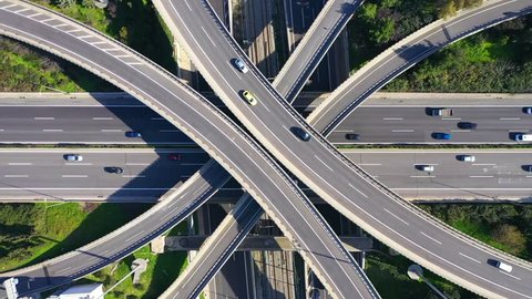Aerial drone timelapse loop video of modern highway multilevel junction with interchange crossing road 