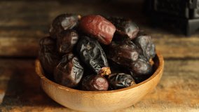 Date fruits on wooden table. Selective focus. Panning to the right.